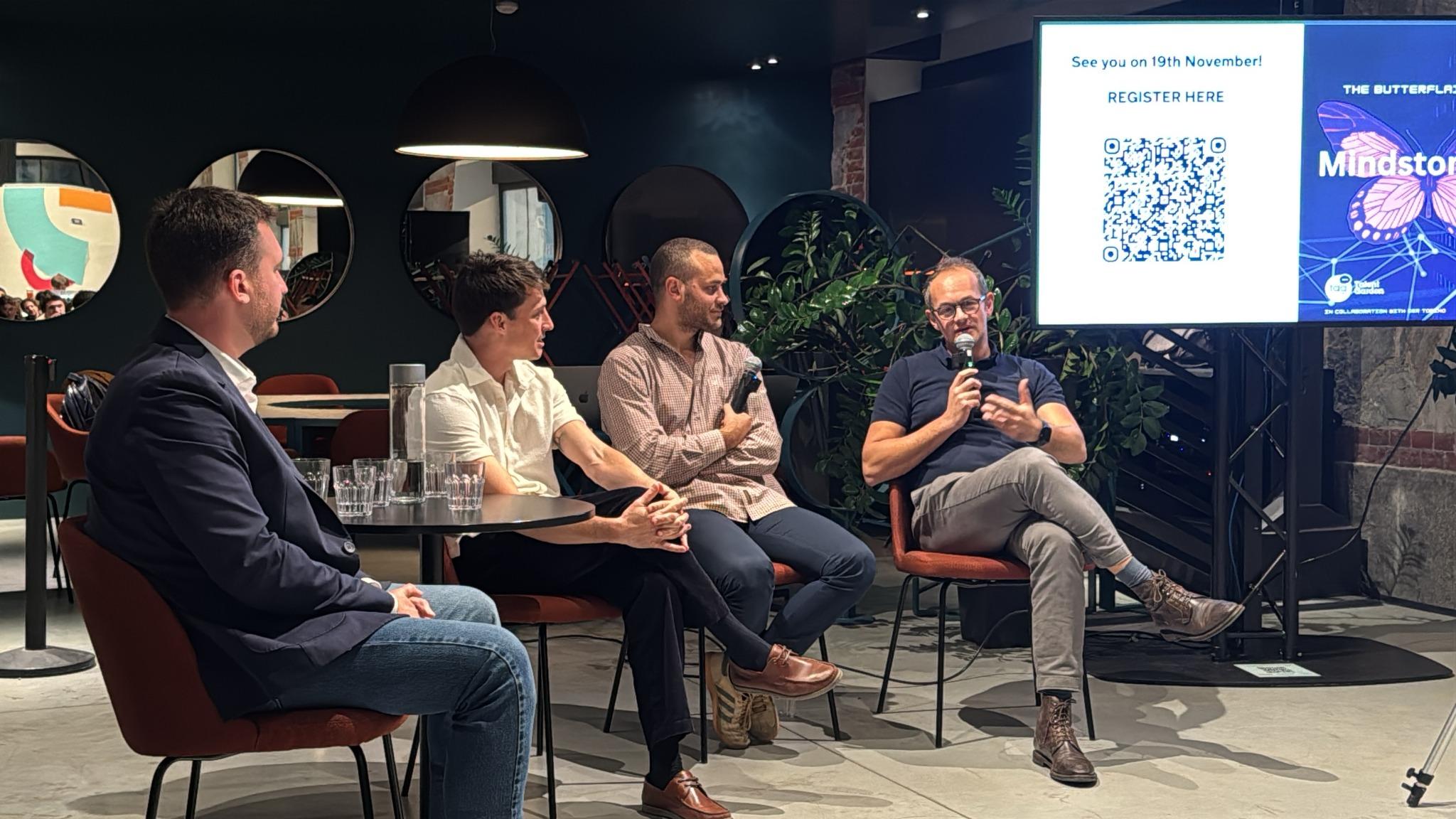 Four participants seated for a panel discussion at the Mindstone AI meetup; the speaker on the right holds a microphone.